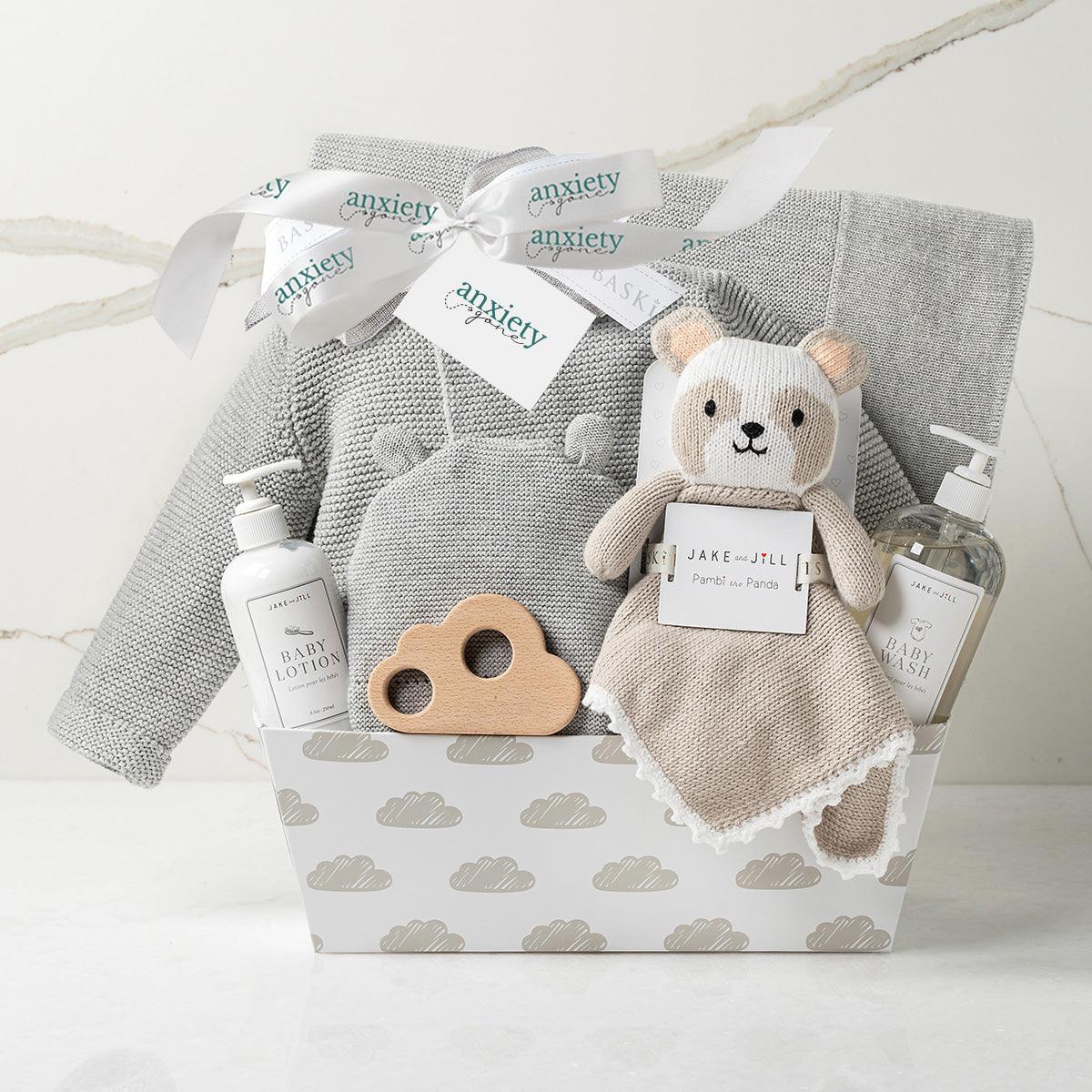 Bundle of Joy New Baby Gift Basket – Gender-neutral gift set with cotton knit sweater, matching hat, cozy blanket, wooden cloud teether, lovie, baby lotion, baby wash, and keepsake cloud base. Perfect for baby showers, personalized baby gifts, and newborn celebrations.