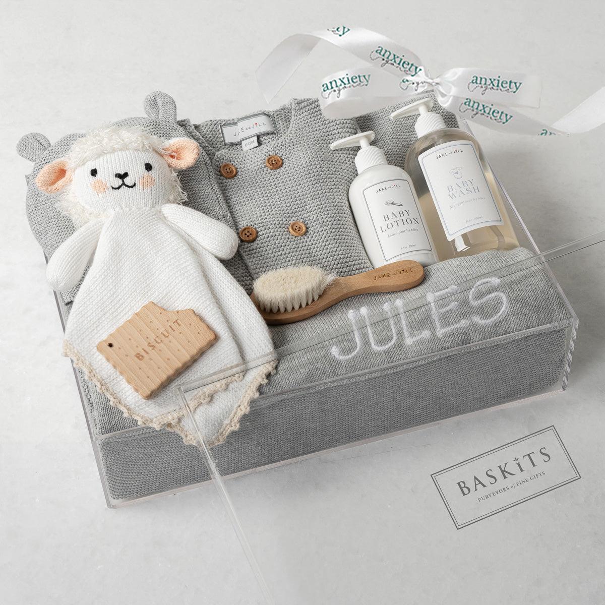 Embroidered Bundle New Baby Gift Box – Personalized baby gift set with cotton knit blanket, button-up sweater, hat, Jellycat Cream Bunny, wooden teether, baby lotion, baby wash, and custom embroidery in a keepsake acrylic box. Perfect for baby showers, newborn gifts, and personalized keepsakes.