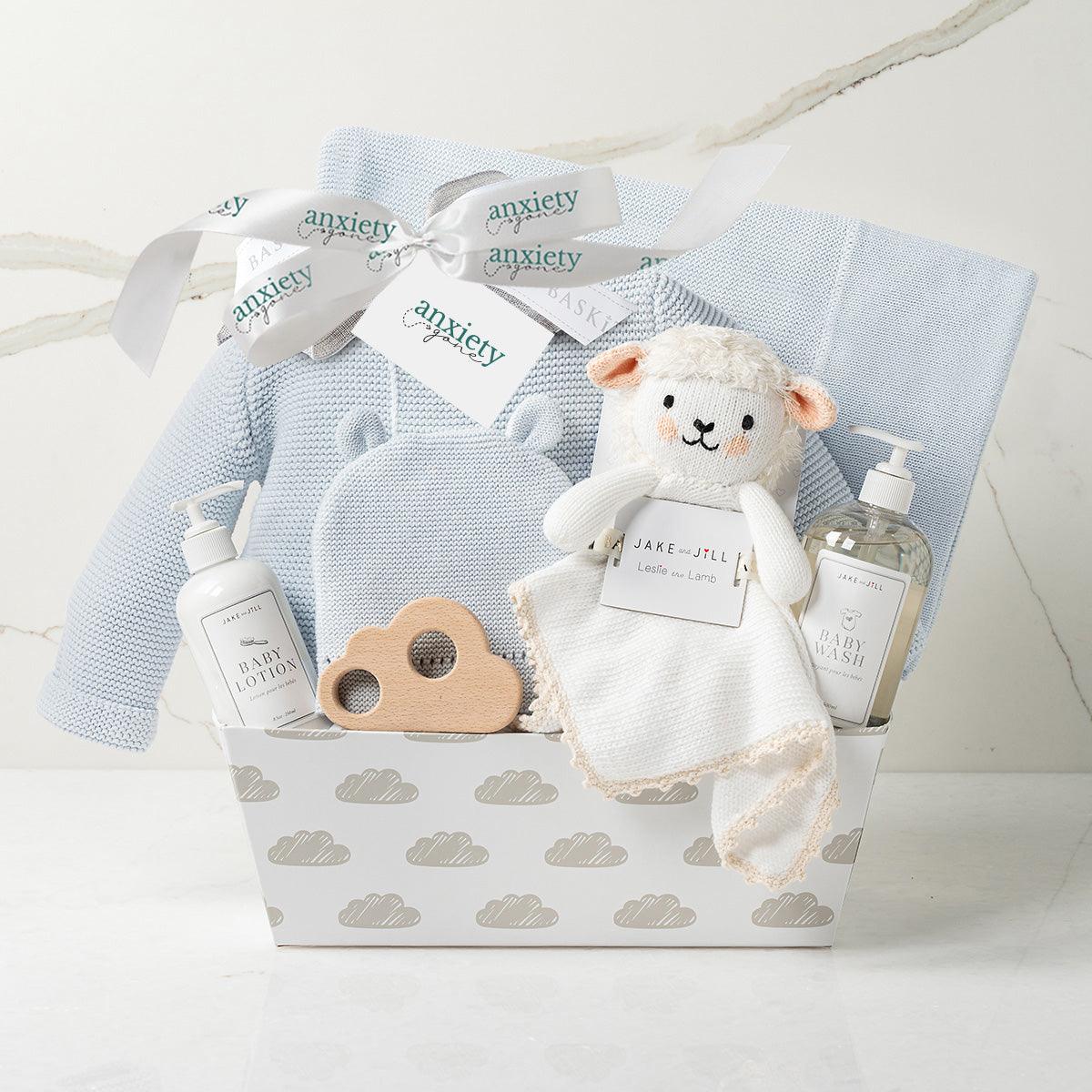 Bundle of Joy Baby Boy Gift Basket – Includes cotton knit sweater, matching hat, cozy blanket, wooden cloud teether, baby lotion, baby wash, lovie, and keepsake cloud base. Ideal for baby showers, newborn gifts, and personalized baby gifts in blue, pink, or grey.