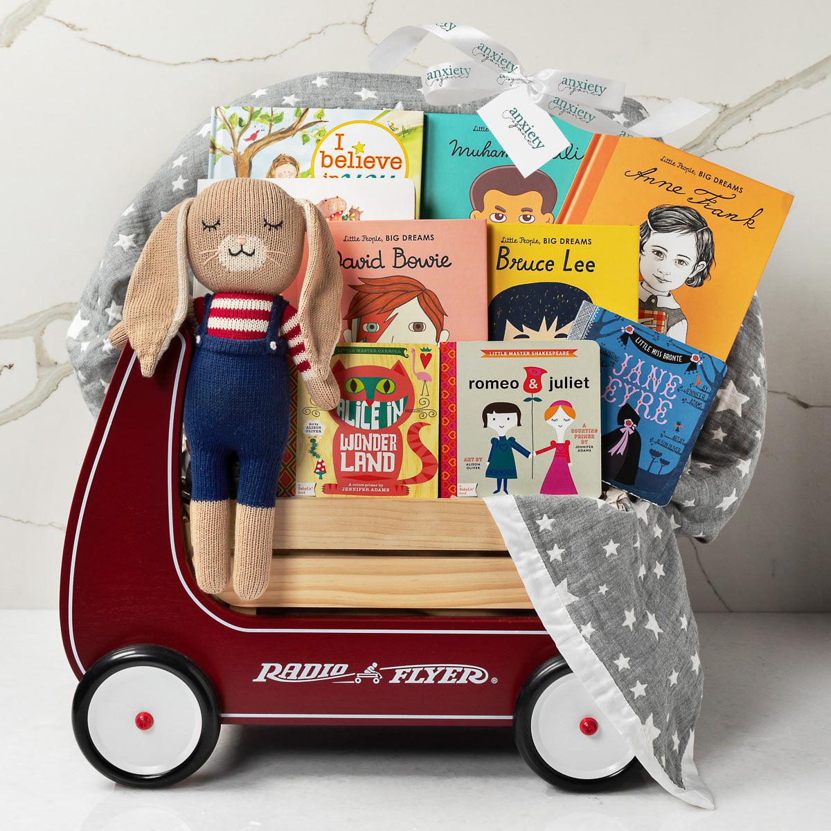 Radio Flyer Baby Gift Set – Unique baby gift basket with Piper Finn baby shoes, Jellycat Hare Bunny, muslin star blanket, Baby Lit classic books, Baby Bird book, The Very Hungry Caterpillar, diversity book, and a Radio Flyer Classic Red Walker Wagon. Ideal for baby showers, newborn gifts, and personalized baby gifts.