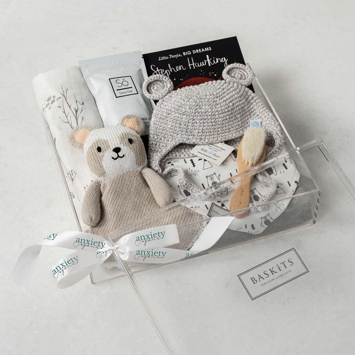 Baby Bear Gift Box – Premium new baby gift basket featuring a crochet knit toque with bear ears, cotton onesie, goat brush, forest-patterned swaddle, plush panda, coconut &amp; oat milk bath, and classic &quot;Brown Bear, Brown Bear&quot; book. Ideal for baby showers, birthdays, or gender-neutral gifts for a newborn.