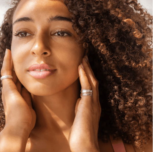 Breeze meditation anxiety ring in sterling silver with 9KT rose gold and yellow gold spinning bands, scalloped edge pattern, displayed with complimentary tin and travel pouch