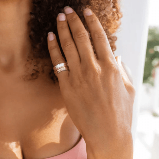 Breeze meditation anxiety ring in sterling silver with 9KT rose gold and yellow gold spinning bands, scalloped edge pattern, displayed with complimentary tin and travel pouch