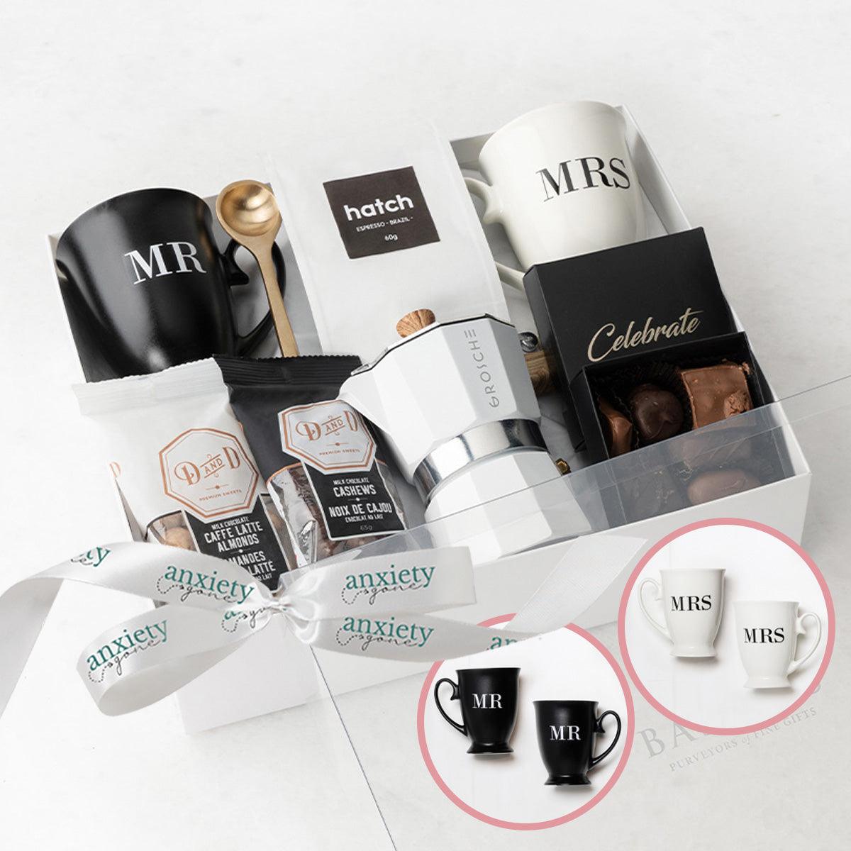 Celebrate Love Gift Box – A thoughtfully curated wedding gift box featuring Mr. &amp; Mrs. mugs, a brass spoon, stovetop espresso maker, and delicious chocolates.