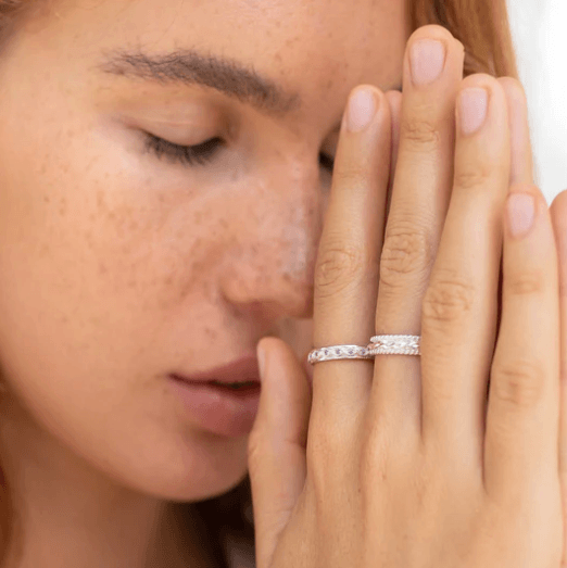 Chakra Sterling Silver Fidgit Ring with bubble edges and twist design spinning band, displayed with complimentary tin