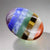 7 Chakra Bonded Worry Stone with thumb indentation for stress relief and chakra healing, using stones for anxiety.