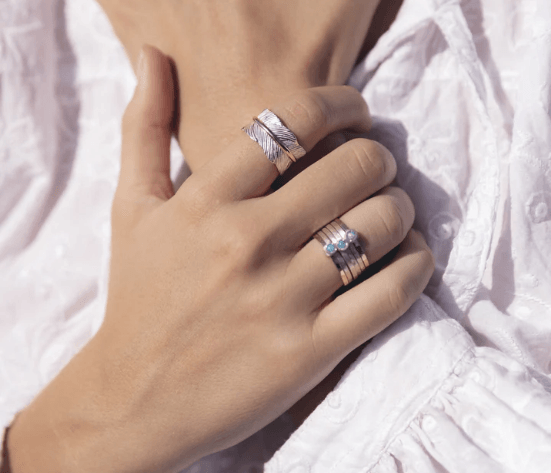 Sterling Silver Meditation Ring with hand-crafted organic leaf pattern and Yellow Gold spinning band, displayed with complimentary MeditationRings Tin and Travel Pouch