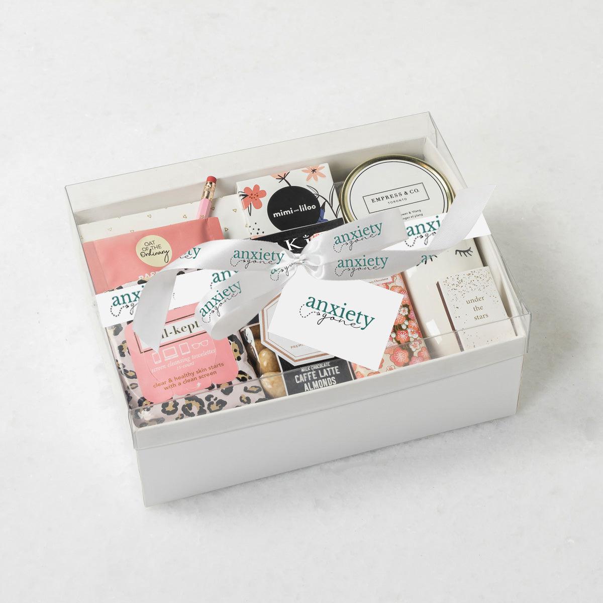 #BOSS Gift Box with luxury self-care items including chocolate, a candle, tea, snacks, and more, elegantly packaged in a keepsake box. Ideal for self-care gifts, thank you gift baskets, get well soon presents, and mental health gifts.