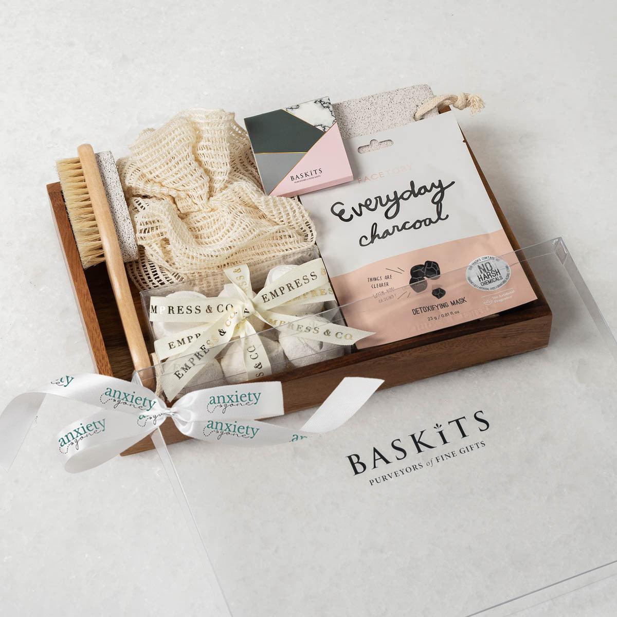 Spa Essentials Mental Health Gift Box featuring luxurious self-care items like lavender bath bombs, face masks, foot care products, and a wooden tray—perfect for self-care gifts, spa gift baskets, and mental health gifts.