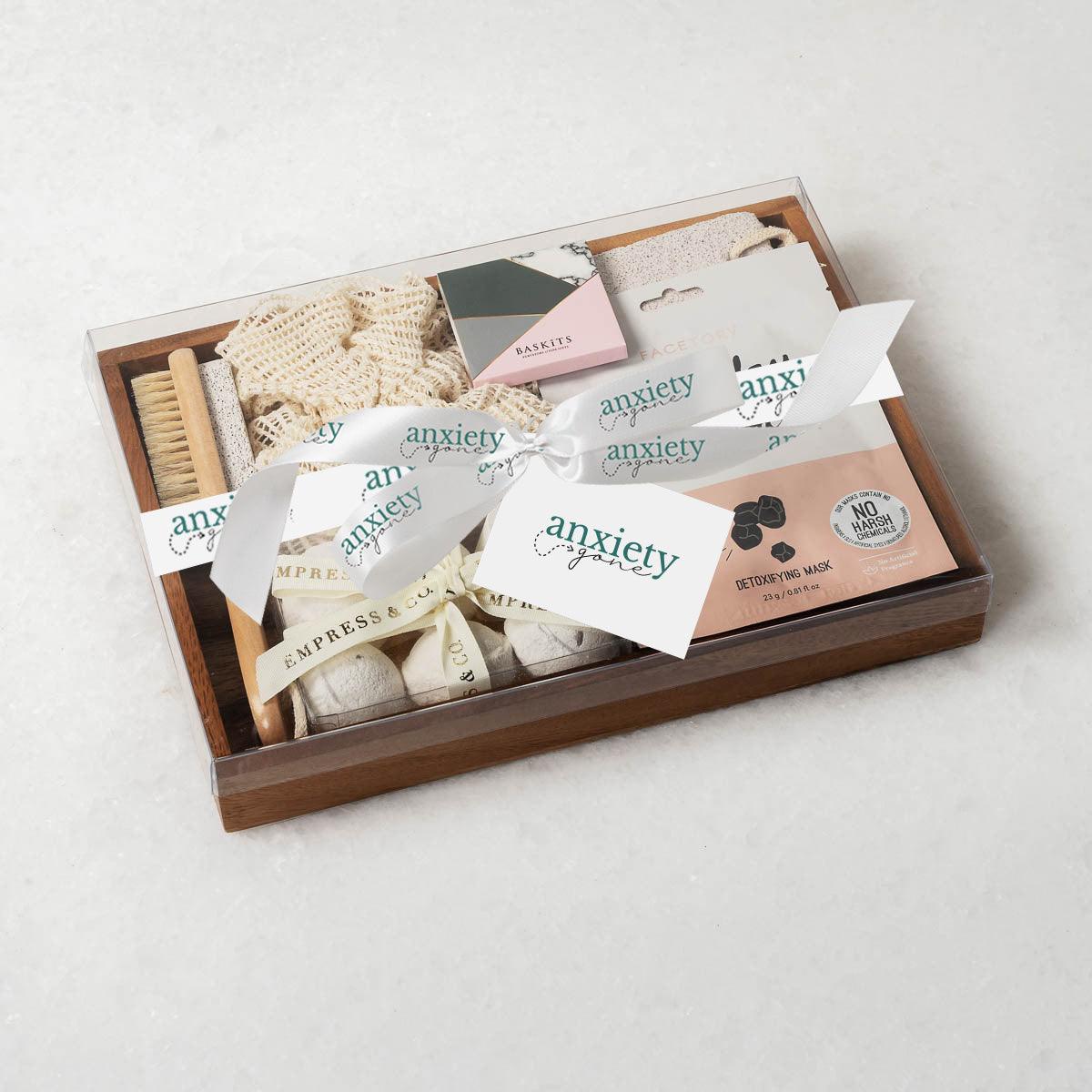 Spa Essentials Mental Health Gift Box featuring luxurious self-care items like lavender bath bombs, face masks, foot care products, and a wooden tray—perfect for self-care gifts, spa gift baskets, and mental health gifts.