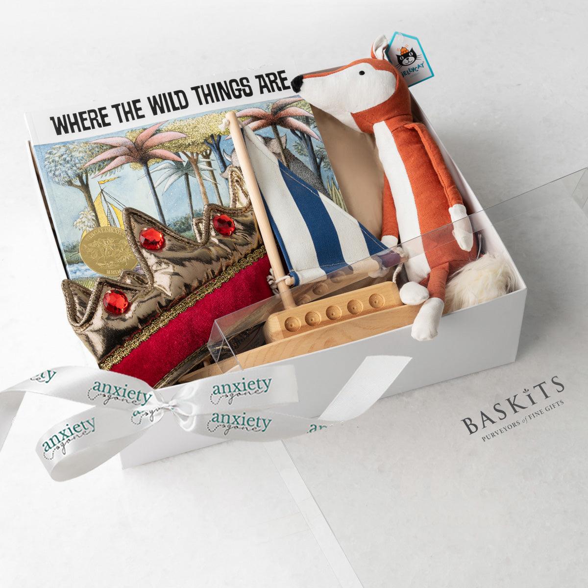 Where the Wild Things Are Gift Basket – Unique baby gift basket with wooden sailboat, gender-neutral crown, Jellycat fox plush, classic children&#39;s book, and keepsake box. Ideal for baby showers, new baby gift baskets, personalized baby gifts, and baby boy or girl gift ideas. Perfect for inspiring imagination and childhood adventures.