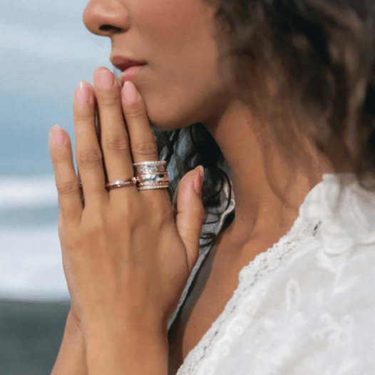 Sterling Silver Gold Fidget Ring with hammered spinning band, Rose Gold flower pattern, and Yellow Gold spinning band, displayed with complimentary MeditationRings Tin and Travel Pouch