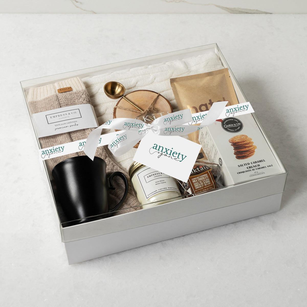 Keeping It Cozy Gift Collection featuring premium self-care items like a cable knit blanket, gourmet treats, coffee, and candles—perfect for self-care gifts, get well soon gifts, and thank you gift baskets.