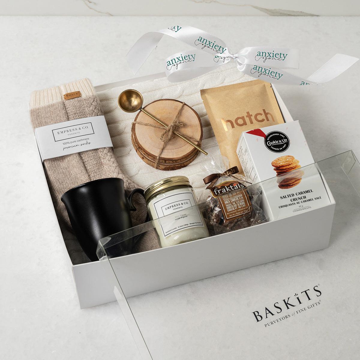 Keeping It Cozy Gift Collection featuring premium self-care items like a cable knit blanket, gourmet treats, coffee, and candles—perfect for self-care gifts, get well soon gifts, and thank you gift baskets.