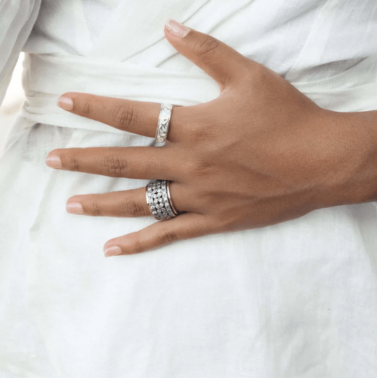 Sterling Silver Figit Ring with brushed rose-outlined spinning band, displayed with complimentary MeditationRings Tin and Travel Pouch