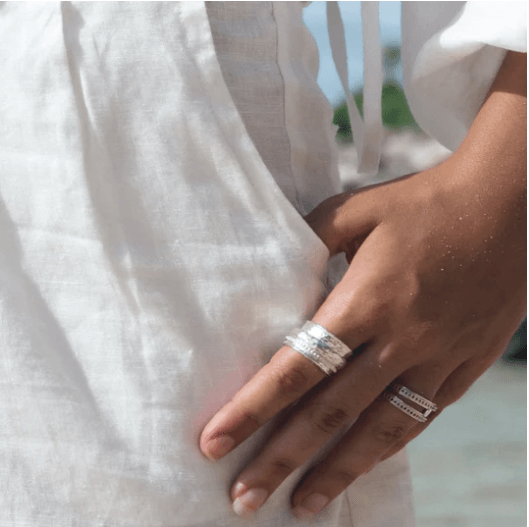 Sterling Silver Spin Ring with thick hammered and patterned spinning bands, displayed with complimentary MeditationRings Tin and Travel Pouch