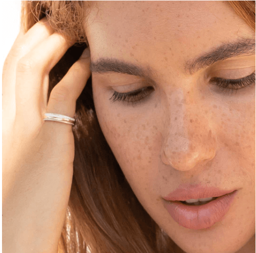 Sterling Silver Spinner Ring with brushed and shiny textures and Yellow Gold spinning band, displayed with complimentary MeditationRings Tin and Travel Pouch