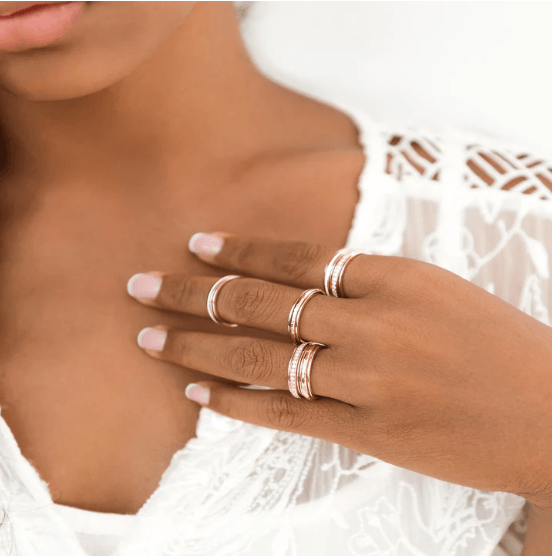 Stackable 14KT Rose Gold Fidget Ring with white enamel spinning band, displayed with complimentary MeditationRings Tin and Travel Pouch