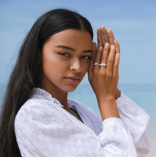 Sterling Silver crystal fidget ring with Aquamarine gemstone and CZ center spinning band, displayed with complimentary MeditationRings Tin and Travel Pouch