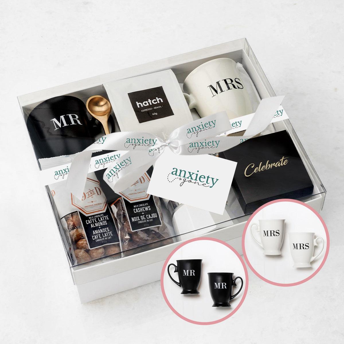 Celebrate Love Gift Box – A thoughtfully curated wedding gift box featuring Mr. &amp; Mrs. mugs, a brass spoon, stovetop espresso maker, and delicious chocolates.