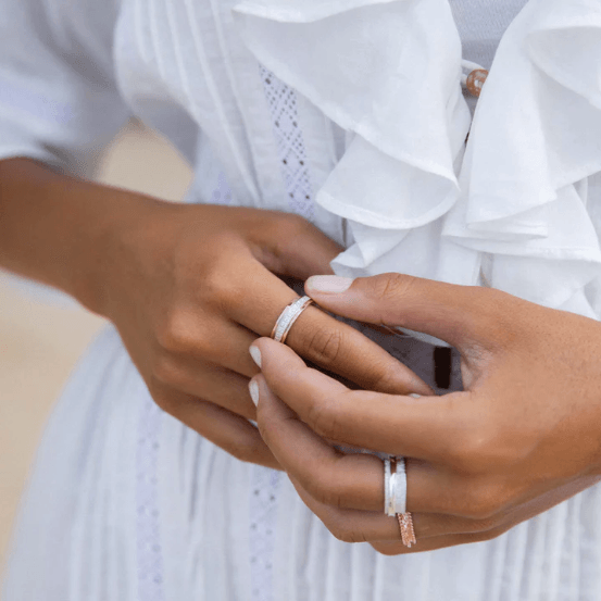 Sterling Silver Spin Ring with Rose Gold accents and CZ spinner, displayed with complimentary MeditationRings Tin and Travel Pouch