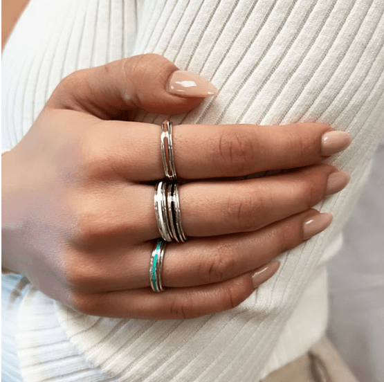 Sterling Silver Fidget Ring for kids  and adults with enamel spinning bands in rose, turquoise, and white, displayed with complimentary MeditationRings Tin and Travel Pouch