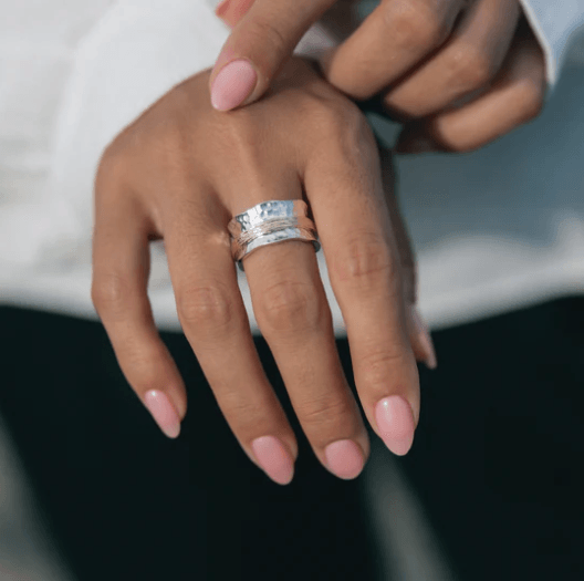 Sterling Silver Fidgit Ring with thick Yellow Gold spinning band and scalloped edges, displayed with complimentary MeditationRings Tin and Travel Pouch