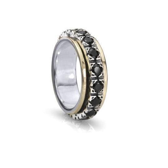 Sterling silver meditation spinning ring with 10KT Yellow Gold edges and large Black CZ spinning band, displayed with complimentary tin and travel pouch