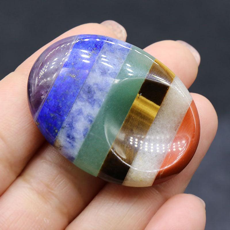 7 Chakra Bonded Worry Stone with thumb indentation for stress relief and chakra healing, using stones for anxiety.