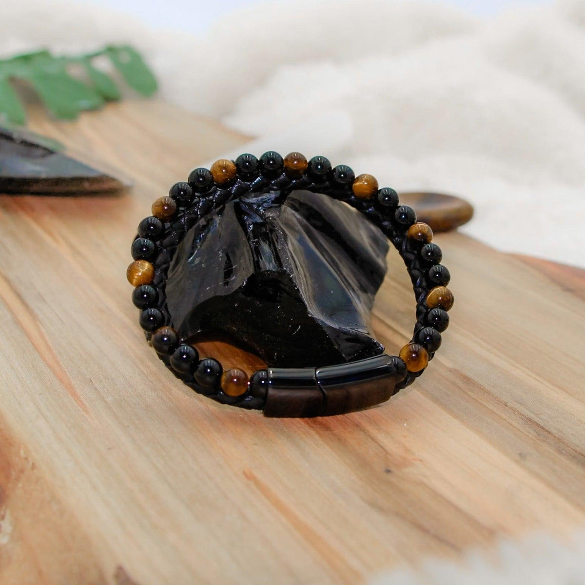 Tiger&#39;s Eye Leather Bracelet with braided black leather for mental clarity and emotional strength.